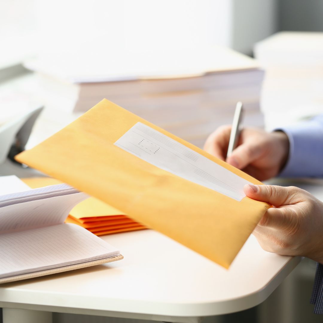 Person holding envelope