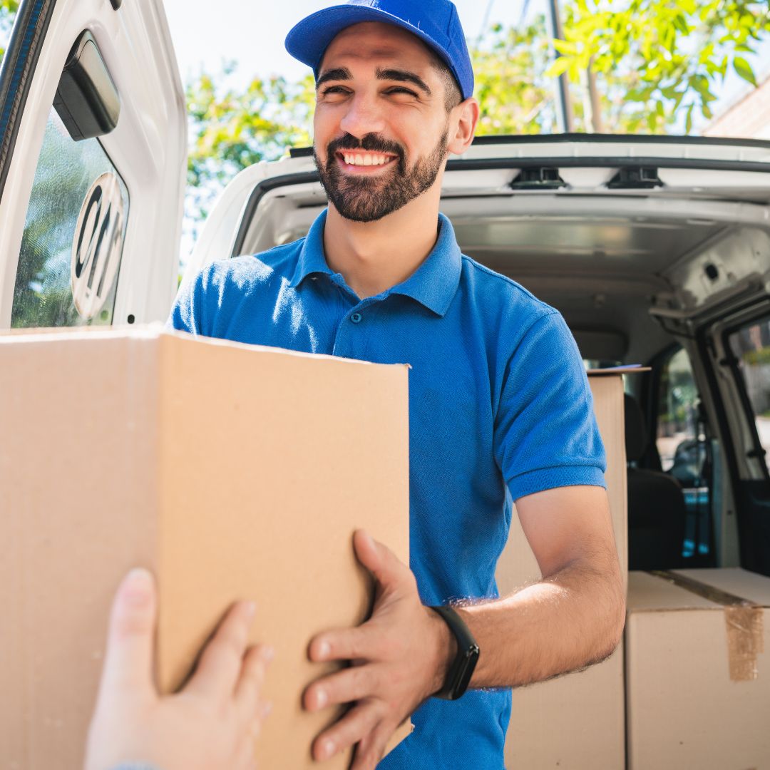 man handing boxes to customer