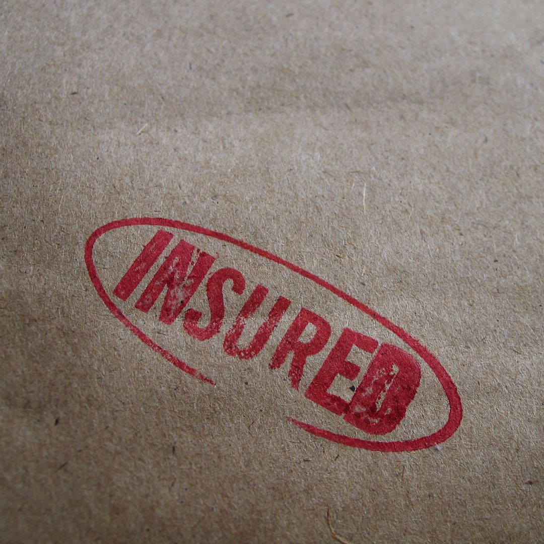 Brown paper with 'insured' stamped in red ink
