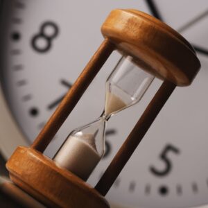 hourglass in front of a clock