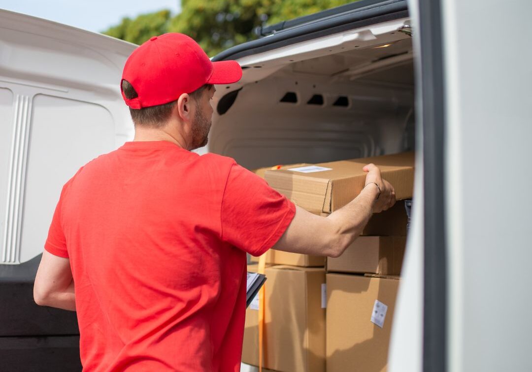 Man loading a truck with packages.